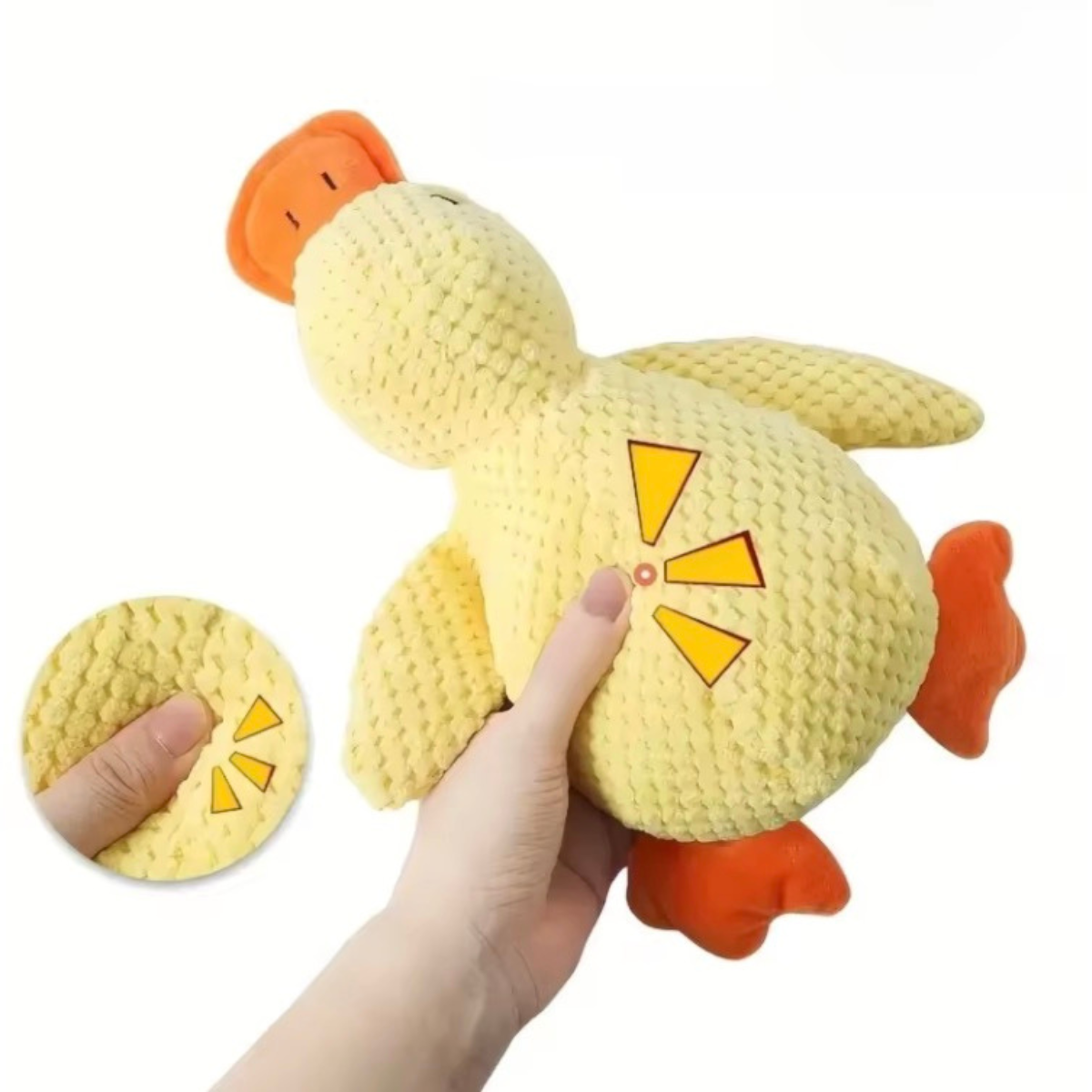 Yellow plush toy with orange accents held by a hand on a white background