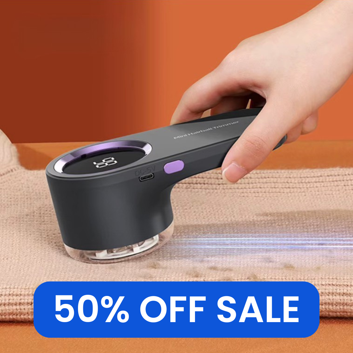 Hand holding a black and purple device on a textured surface with a 50% off sale label.