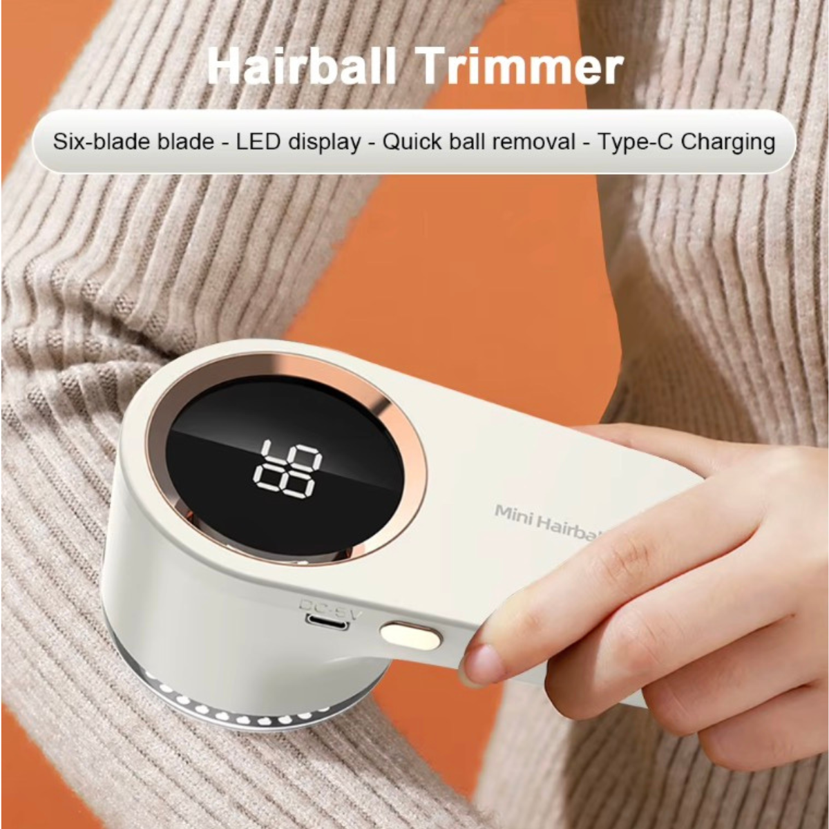 Hairball trimmer with digital display held by a person against an orange background